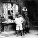 Children look at Christmas cards in New York, 1910.